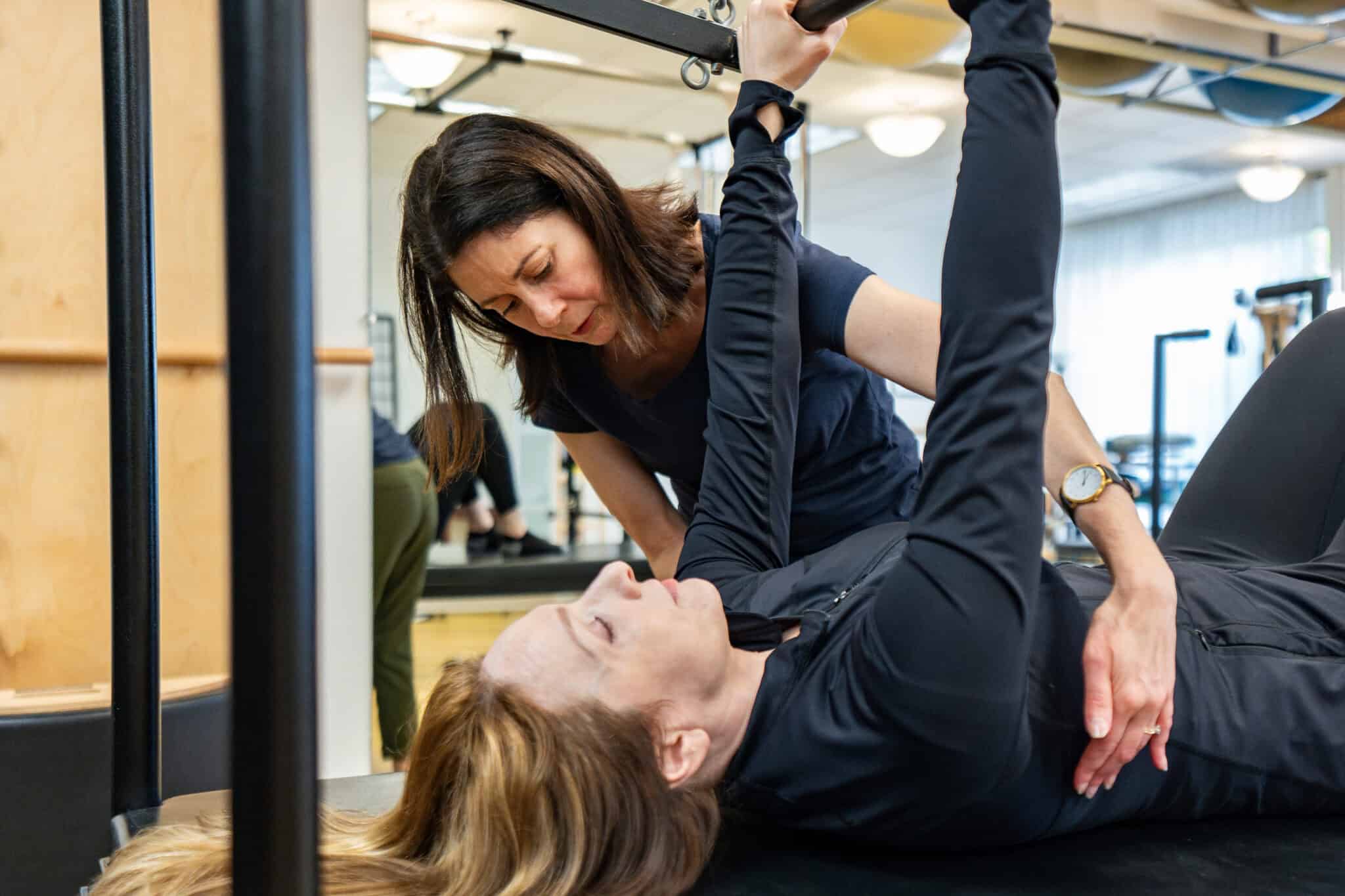 Leslie Braverman teaching a client on the STOTT PILATES Cadillac.